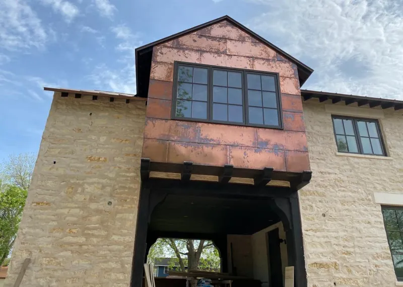 Copper metal panel facade on a stone building for Roof Repair in Oroville East