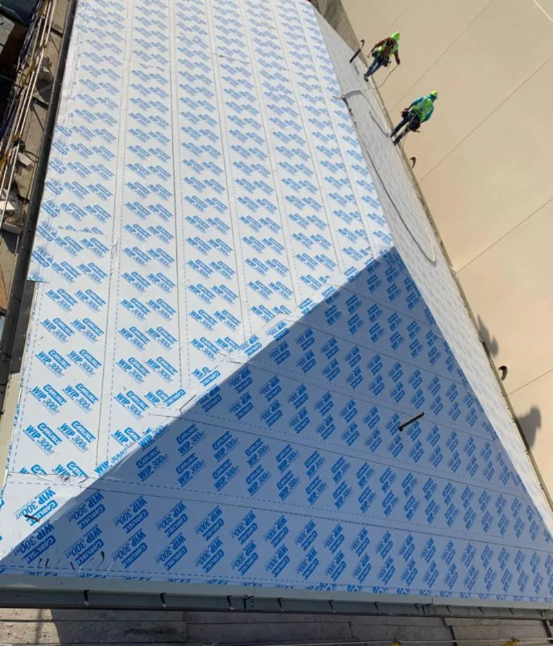 Professional roofers installing underlayment on a metal roof in Oroville East